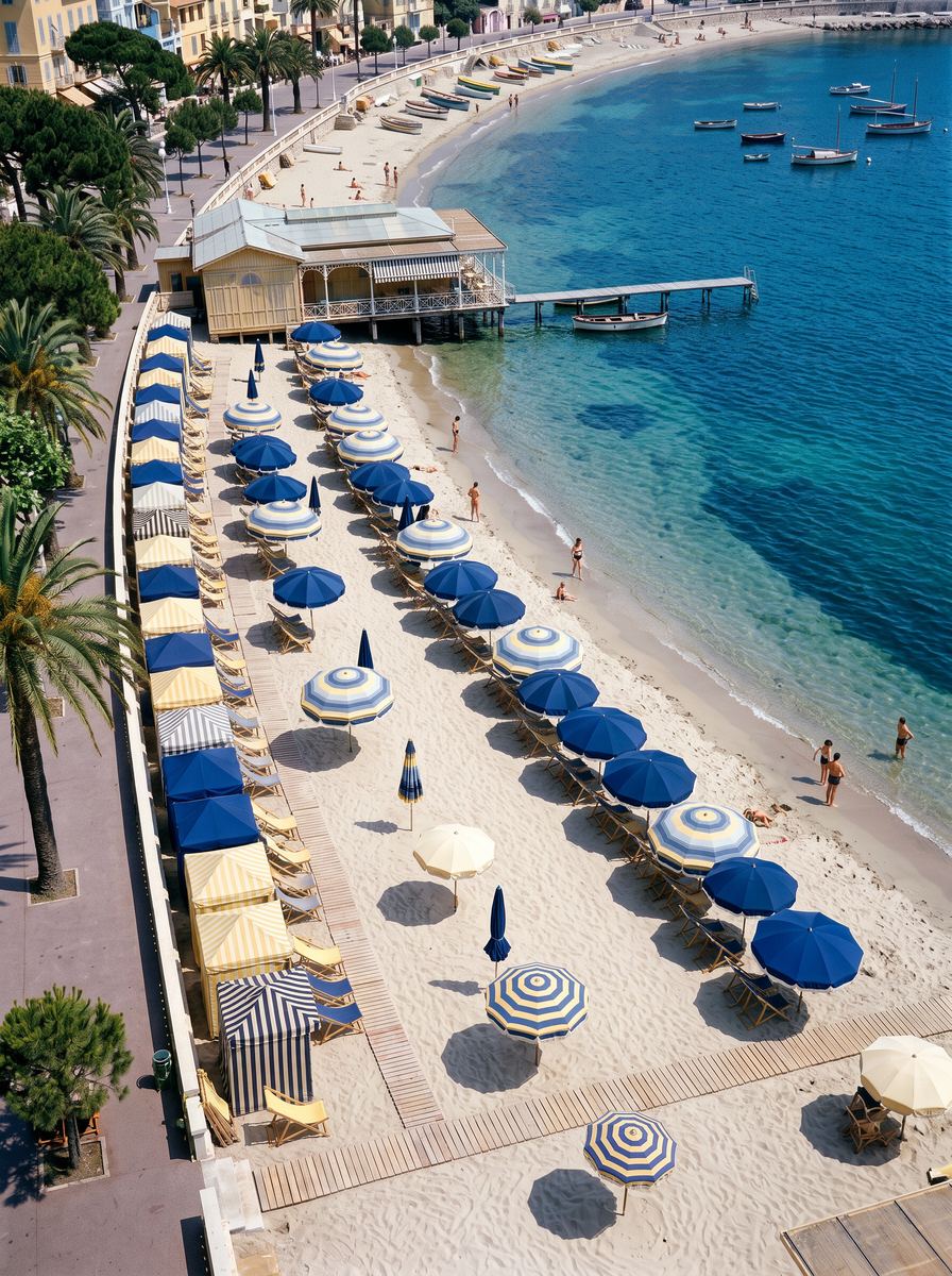 La plage vue d’en haut, les parasols bleus alignés le long de la courbe de la baie